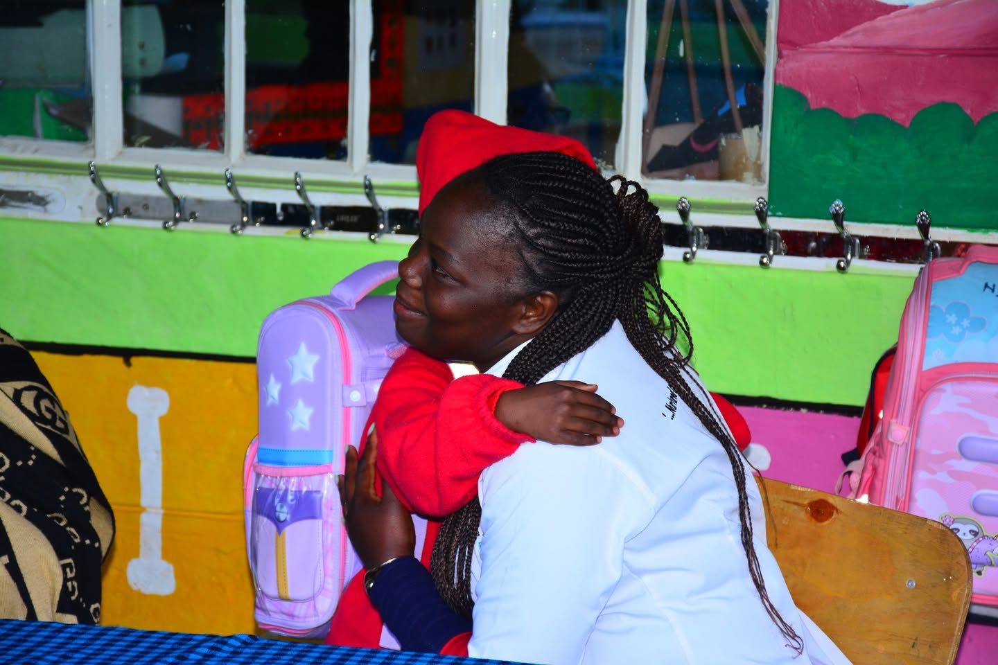 A teacher embracing a pupil at St. Nicholas Junior Academy
